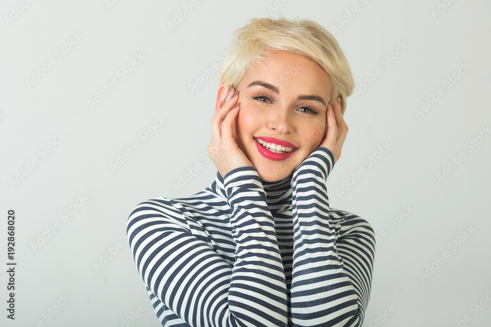 happy beautiful young girl with a smile on her face with a short hairstyle on a light background happy beautiful young girl with a smile on her face with a short hairstyle on a light background