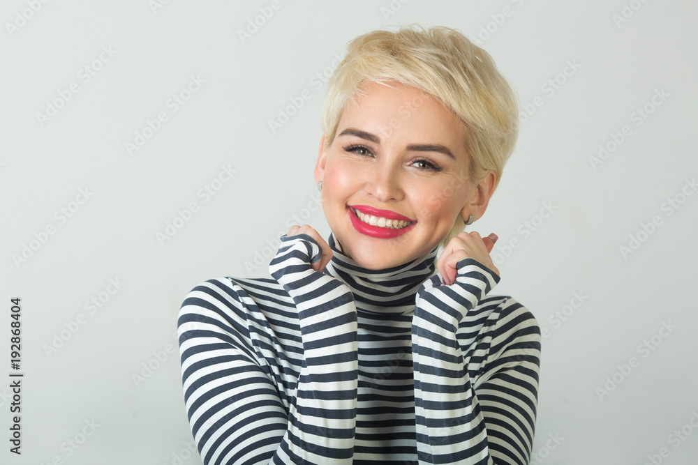 happy beautiful young girl with a smile on her face with a short hairstyle on a light background happy beautiful young girl with a smile on her face with a short hairstyle on a light background