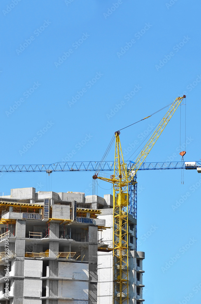 Crane and highrise construction site Crane and highrise construction site