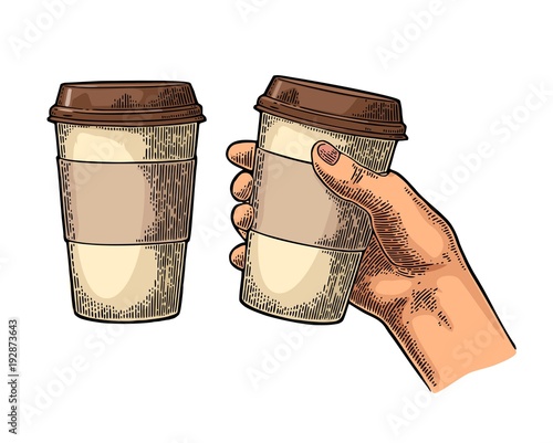 Hand holding a disposable cup of coffee with cardboard holder and cap.