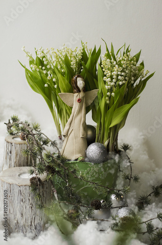 Beautiful romantic composition - Spring lilies of the valley  an angel statue and beautiful decor