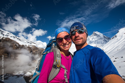 Couple makes selfie in the mountains on the way to Annapurna base camp