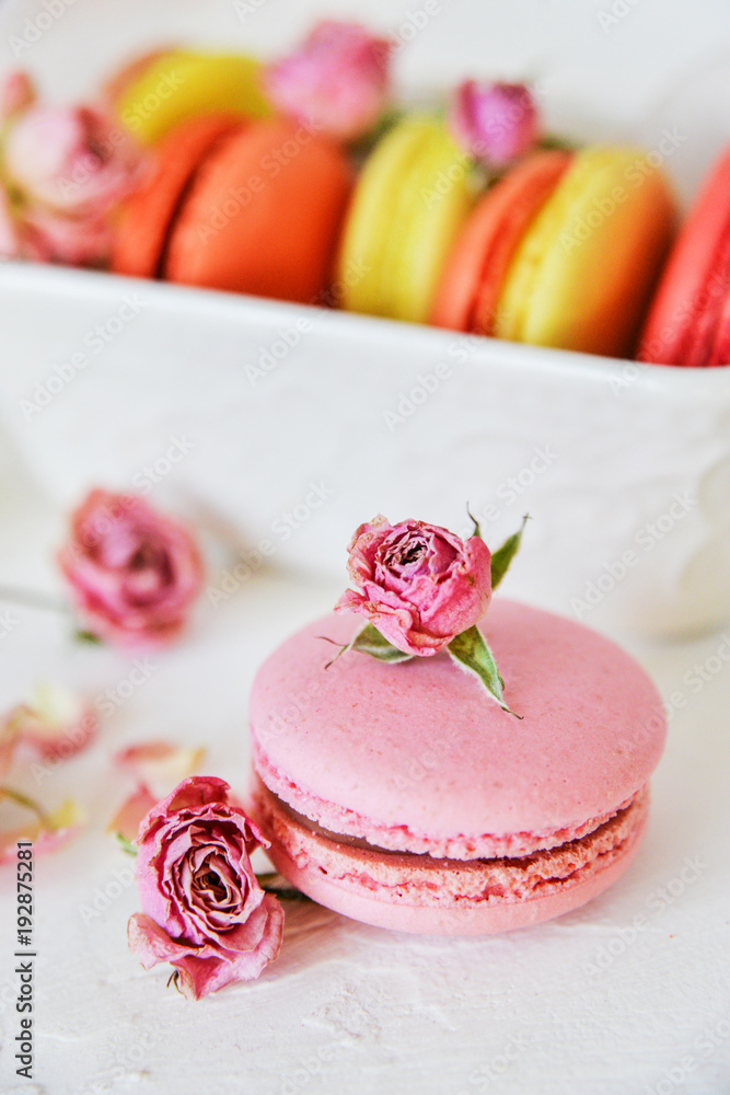 Dessert: A Delicate Fresh Colorful French Macaroons In Pastel Colors Gift Box Flowers Roses On Light Textiles Background