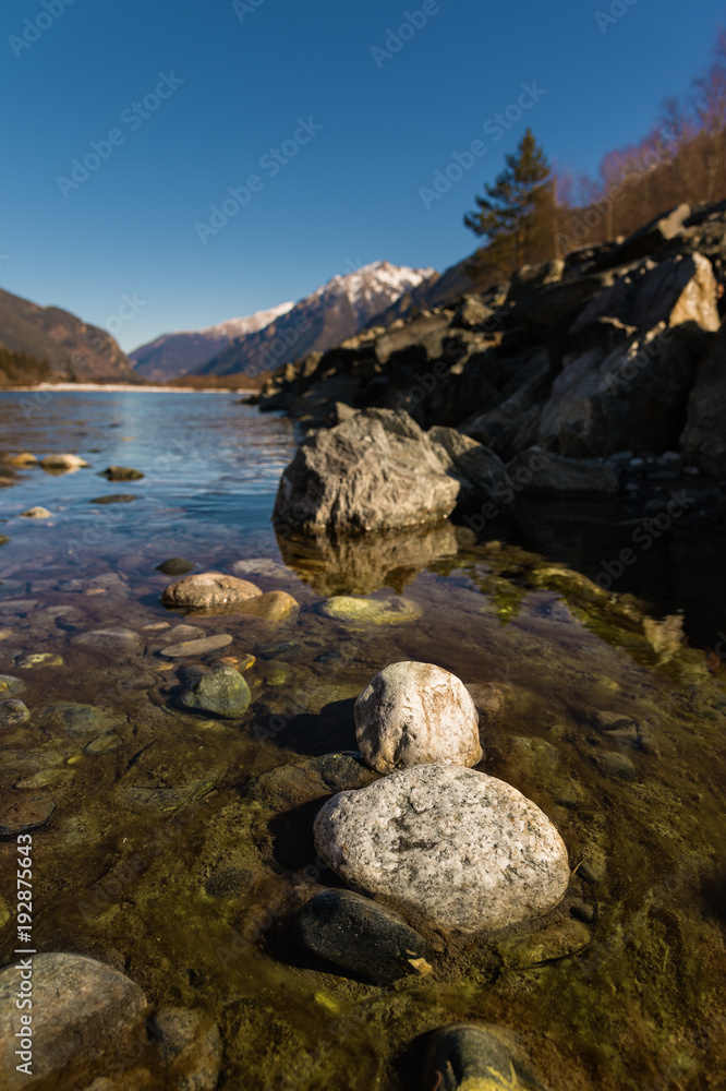 Midday Autumn landscape calm river in the Caucasus Mountains with rocks in the near term Midday Autumn landscape calm river in the Caucasus Mountains with rocks in the near term