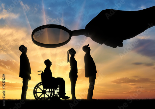 Bilde på lerret Employer's hand looks through the magnifying glass to an invalid in a wheelchair