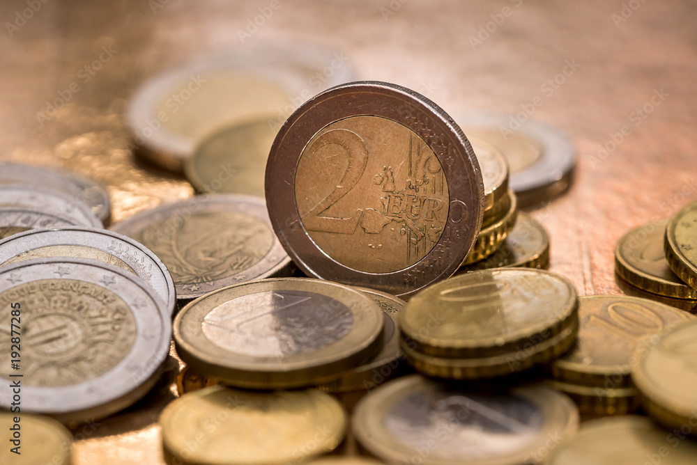 many euro coin isolated on gold close up many euro coin isolated on gold close up
