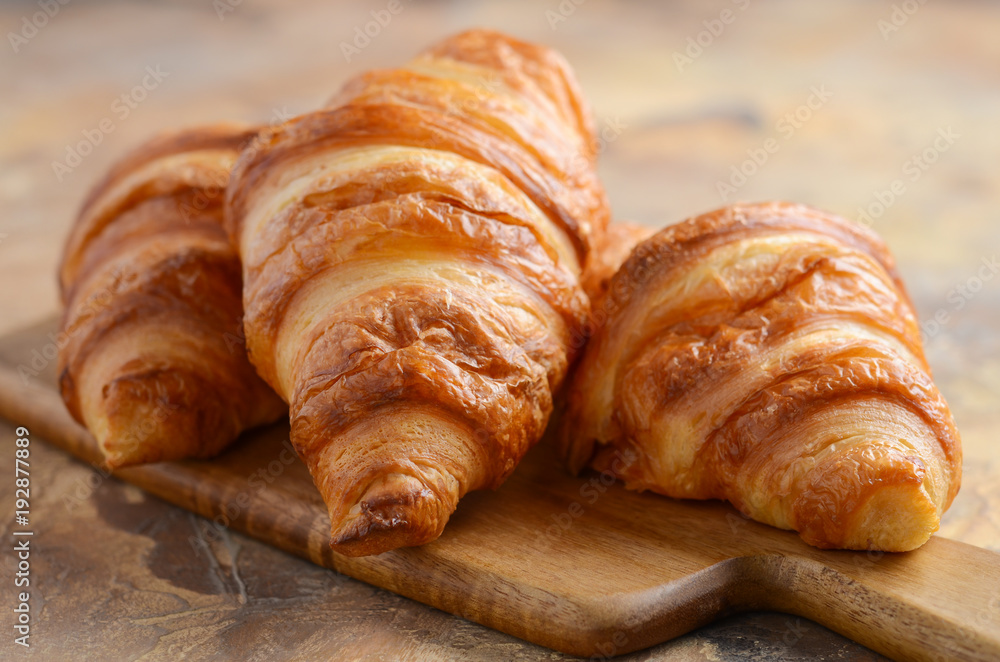 Fresh Croissants on brown concrete background Selective focus Fresh Croissants on brown concrete background Selective focus