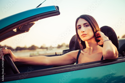 Yyoung woman sitting in cabriolet