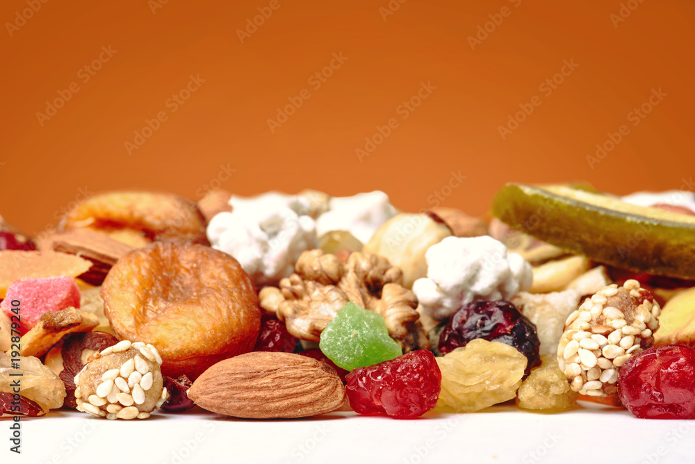 Fototapeta premium Tasty sweet mix dried fruits colorful background. A set of textures of nuts, legumes and dried fruits. 