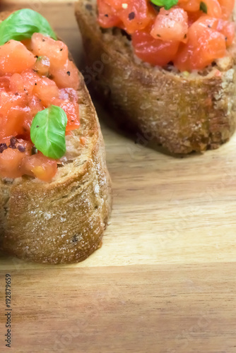 Bruschetta on wooden background with copy space- healthy Italian food - close up, macro shot