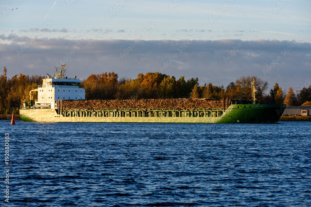 Naklejka premium cargo ship is leaving port sailing away
