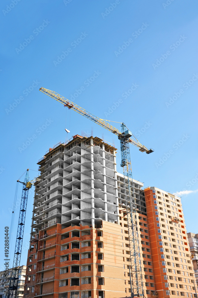 Crane and highrise construction site Crane and highrise construction site