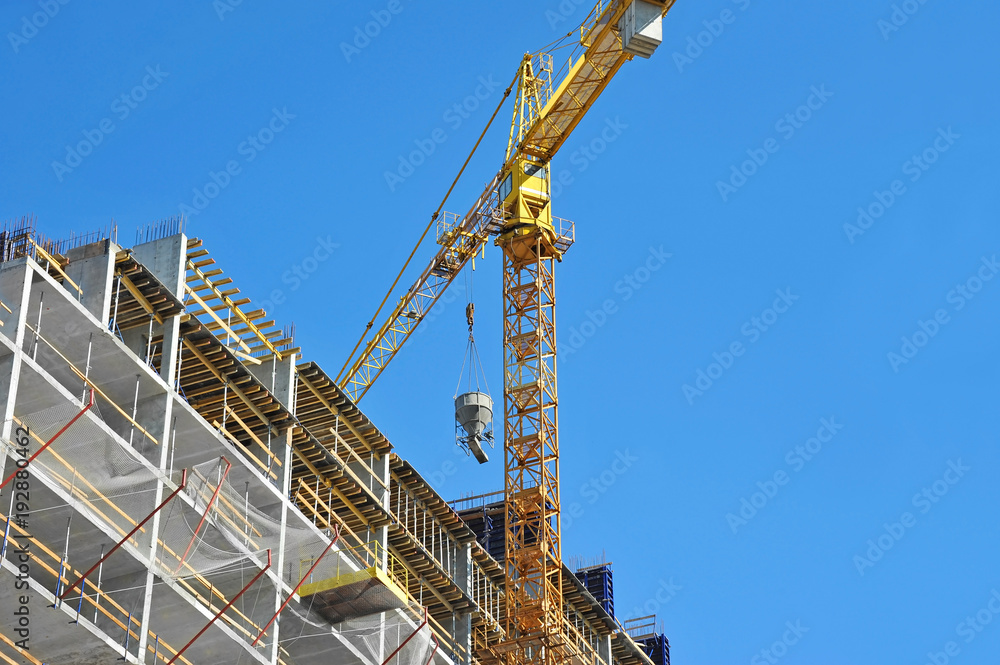 Crane and highrise construction site Crane and highrise construction site
