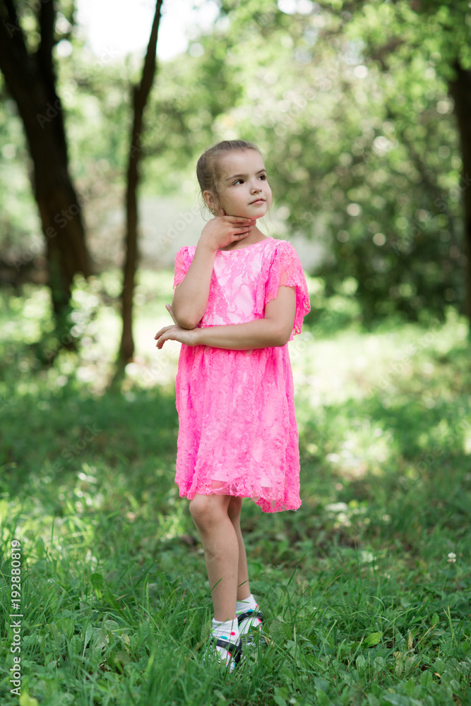 Fashion portrait of stylish girl smiling and posing at camera. Walking in park at summertime. Fashion portrait of stylish girl smiling and posing at camera. Walking in park at summertime.