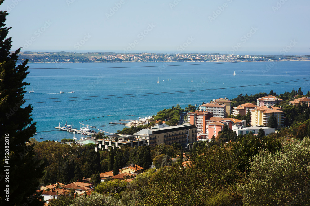 Obraz premium Panorama view of historical town Piran, city close to Portoroz, Slovenia, Europe during spring. Alps, Italy, with snow in the background