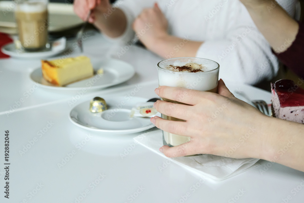 Two friends communicate with food, drink coffee and eat cake. Two friends communicate with food, drink coffee and eat cake.
