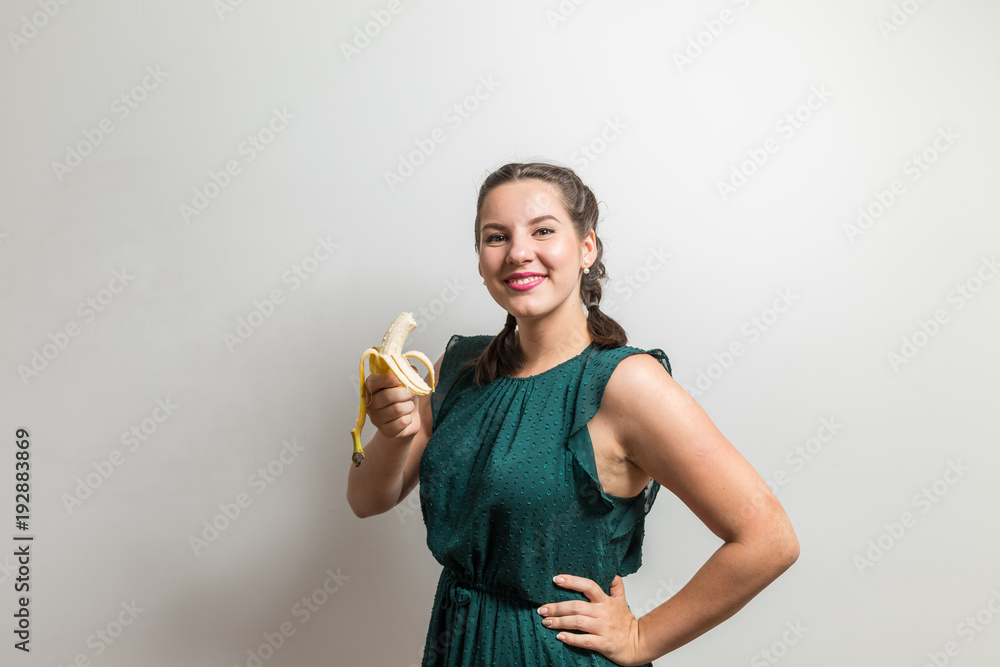 Beautiful caucasian model on white bakcdrop with banana Beautiful caucasian model on white bakcdrop with banana