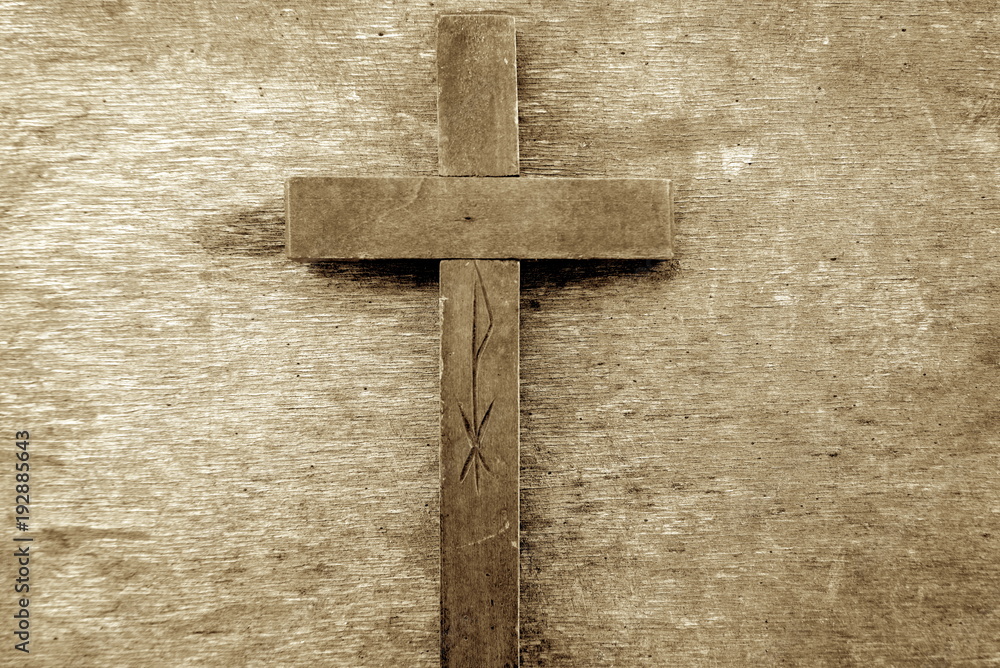 Wooden cross. Old wooden cross on an old wooden background. Sepia 