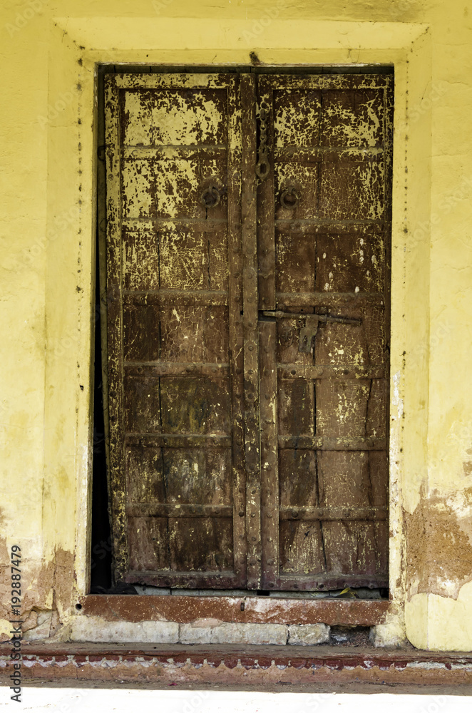 Antique Brown Door used for servants quarters in the City Palace of Udaipur, India Antique Brown Door used for servants quarters in the City Palace of Udaipur, India