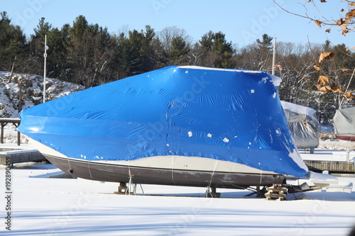 Plastic shrink wrap on boat, to protect boat and interior of boat from the winter elements.   

