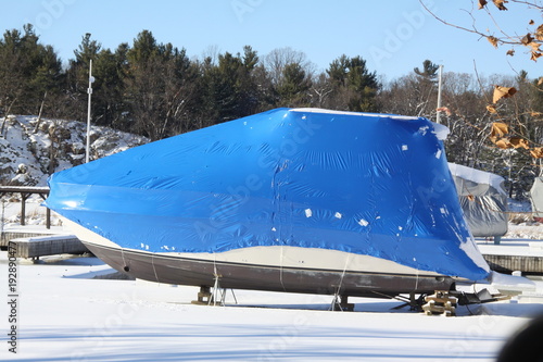 Plastic shrink wrap on boat, to protect boat and interior of boat from the winter elements.   

