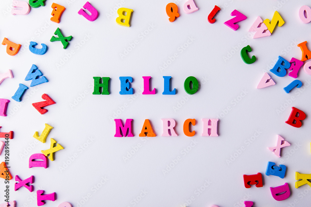 Hello March. Scattered colorful wooden letters