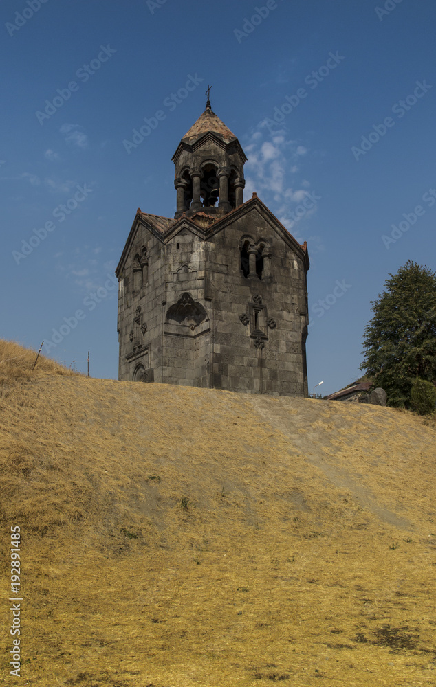 Three navesthe bell tower with the umbrella dome in the monastery of Gregory  in Armenian village of Haghpat