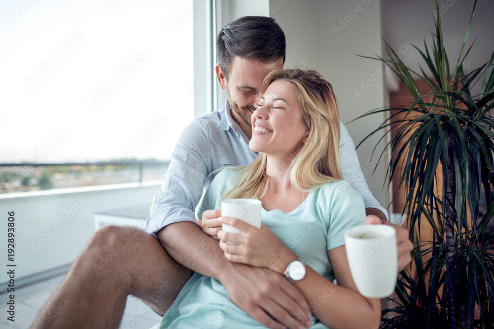 Hugging love couple sitting next to the window. Hugging love couple sitting next to the window.