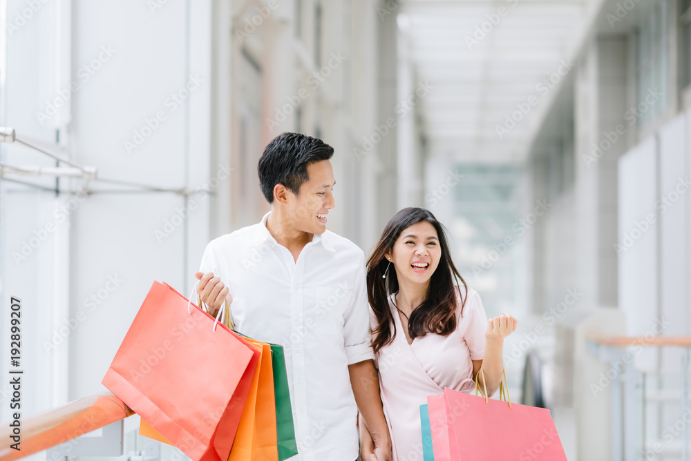 Happy Asian couple enjoy shopping in mall Happy Asian couple enjoy shopping in mall