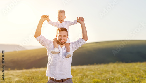  Father's day. Happy family father and toddler son playing and laughing on nature at sunset