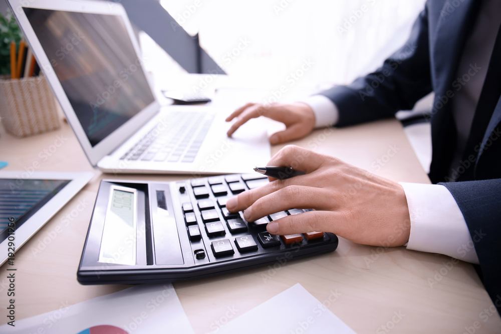 Man working at table in office, closeup. Financial trading concept Man working at table in office, closeup. Financial trading concept