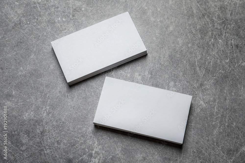 Blank business cards on grey background
