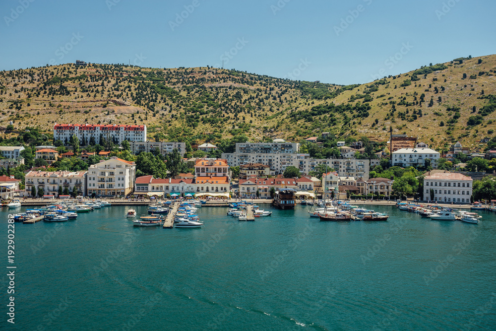 Resort town. Boat parking and modern buildings on the Black Sea coast of the Balaklava bay, Crimea, Russia