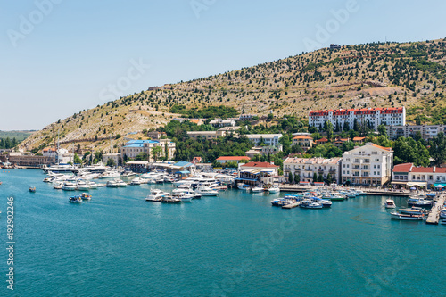 Fototapeta Naklejka Na Ścianę i Meble -  Resort town. Boat parking and modern buildings on the Black Sea coast of the Balaklava bay, Crimea, Russia