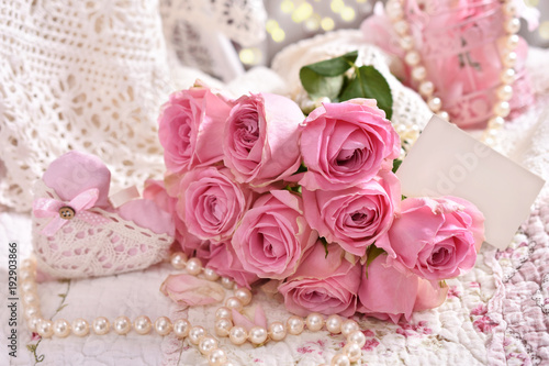 bunch of pink roses with blank card