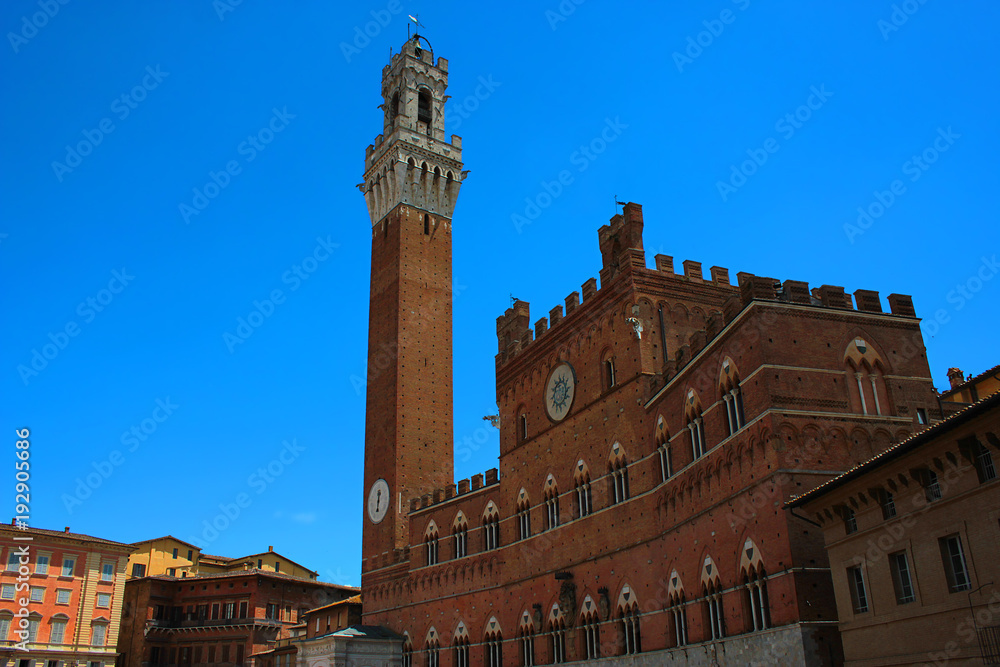 Old building with a tower in Siena, Italy 