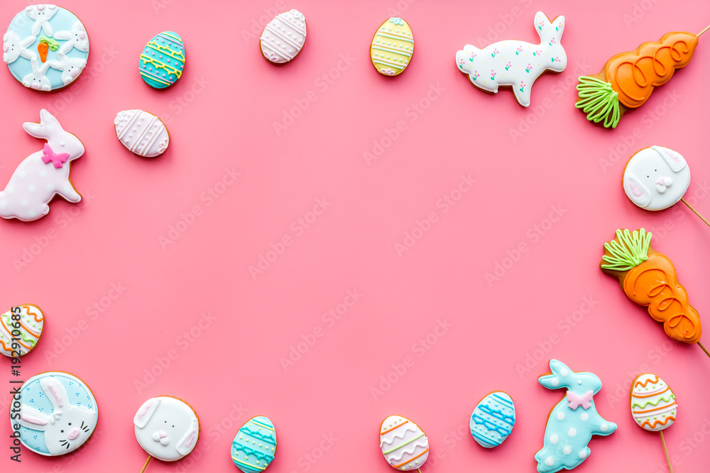 Easter bunny and easter eggs cookies. Easter symbols and traditions. Pink background top view copy space Easter bunny and easter eggs cookies. Easter symbols and traditions. Pink background top view copy space