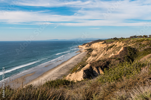 Black s Beach is a secluded section of beach beneath the bluffs of Torrey Pines in San Diego  California  and clothing optional.