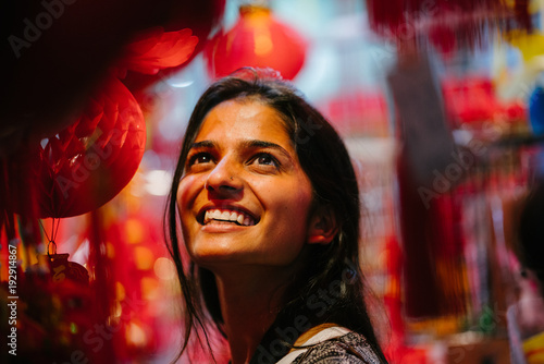 Photography A portrait of a beautiful Indian woman celebrating Chinese new year in a night market in Asia