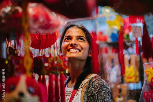 Canvas Print A portrait of a young Indian lady wandering during the Chinese New Year festival in Asia at night on the market