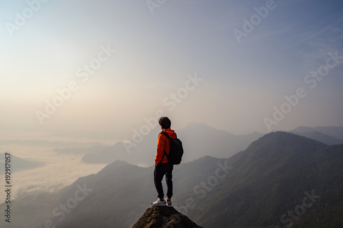 Young traveler standing and looking at beautiful landscape