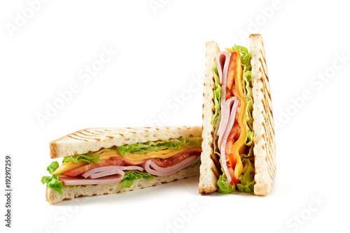 Sandwich with ham, cheese, tomatoes, lettuce, and toasted bread. Front view isolated on white background.