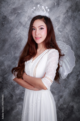 portrait of beautiful young woman angel with arm crossed