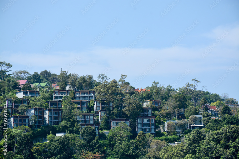 Fototapeta premium buildings among tropical trees in Thailand