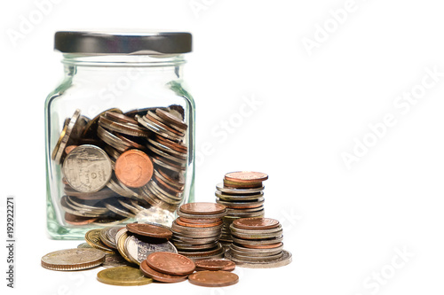 Coins in glass jar and outside, Thai currency money on white background for business and finance concept