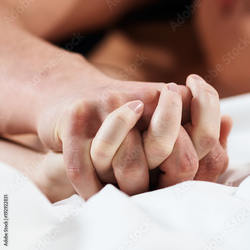 Foto Focused on hands of passion couple having sex.