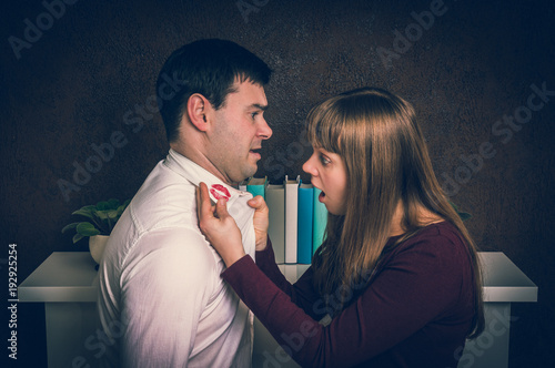 Wife finded red lipstick on shirt collar - infidelity concept photo