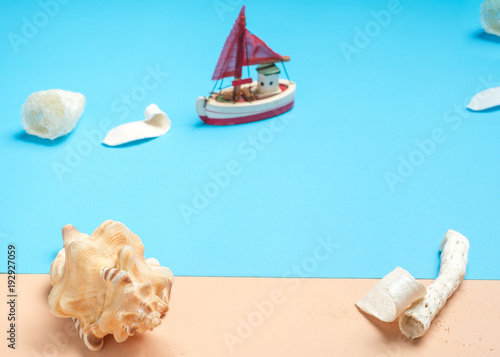 Fototapeta Naklejka Na Ścianę i Meble -  Set of summer object Sea Shell,boat,coral, starfish, and sand on pastel beige and blue background.Holiday vacation backdrop.Copy space for display of product or content design.