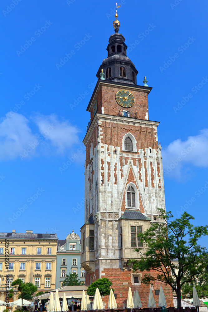  Town hall tower on main market square in Krakow in Poland on blue sky background