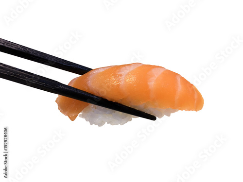 close up of chopsticks taking portion of sushi roll on the table restaurant / eating sushi roll using chopsticks